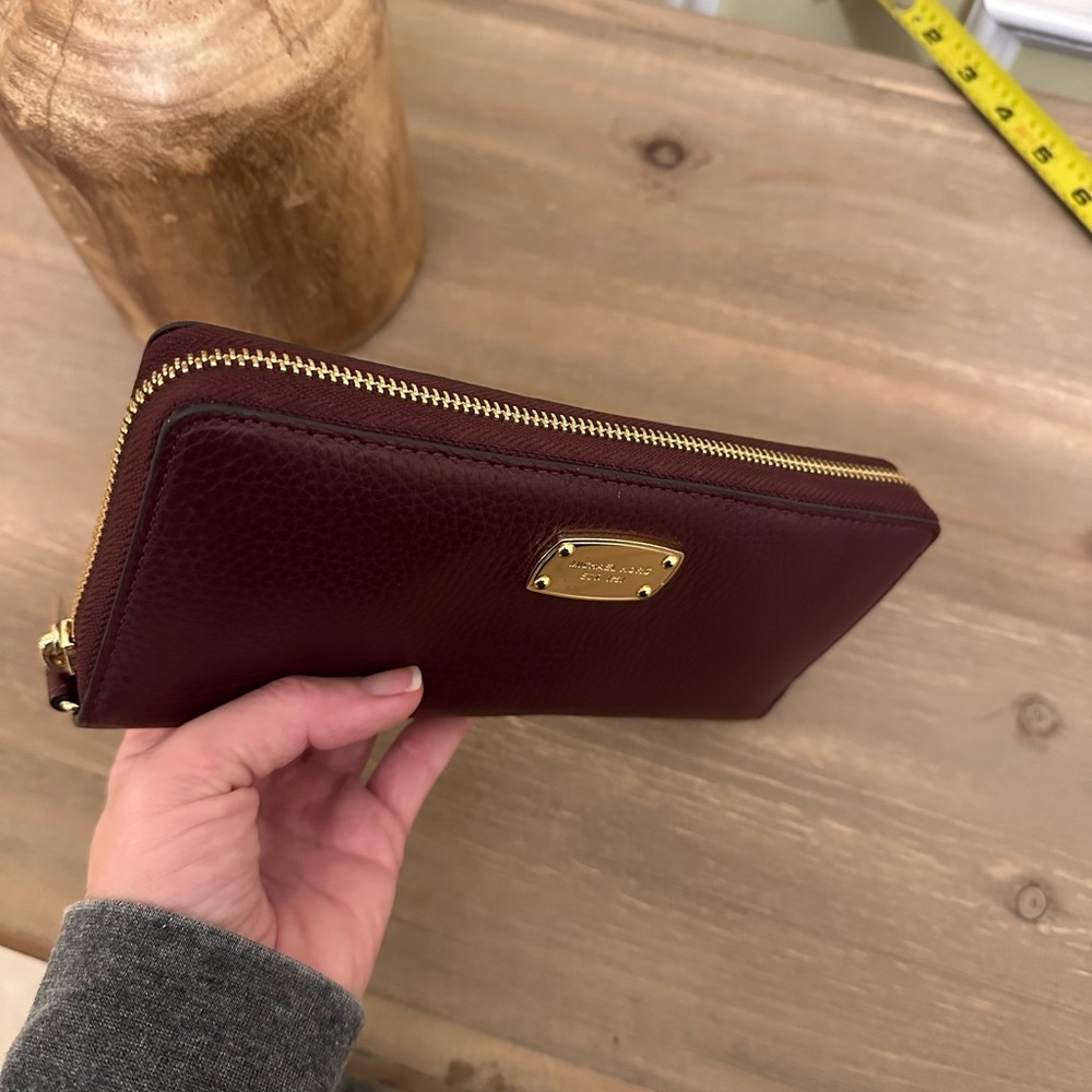 Michael Kors maroon zip around wallet.